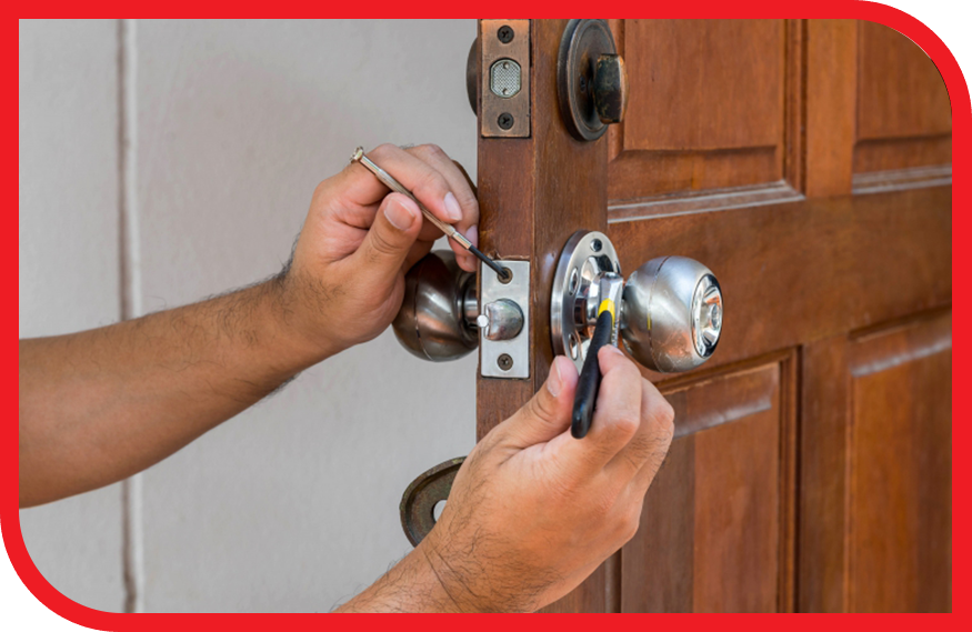 Locksmith working on the lock of a home.